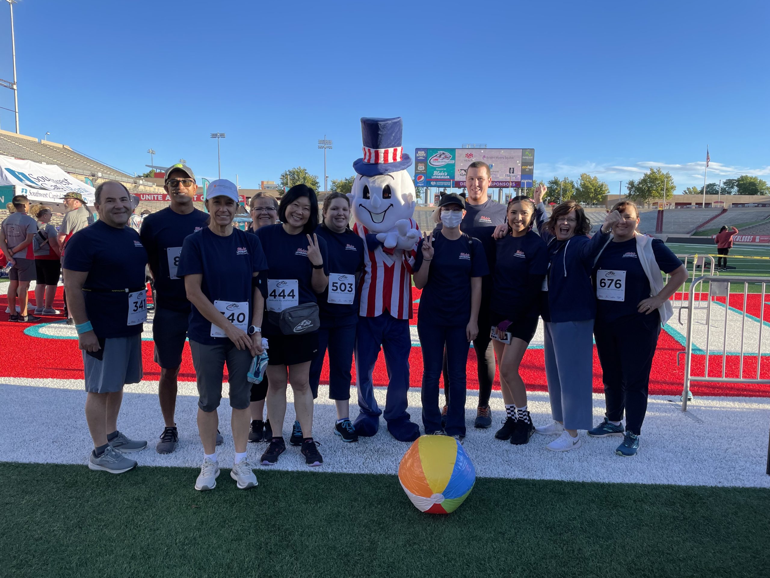 Blake's team group photo at field goal with mascot and beach ball