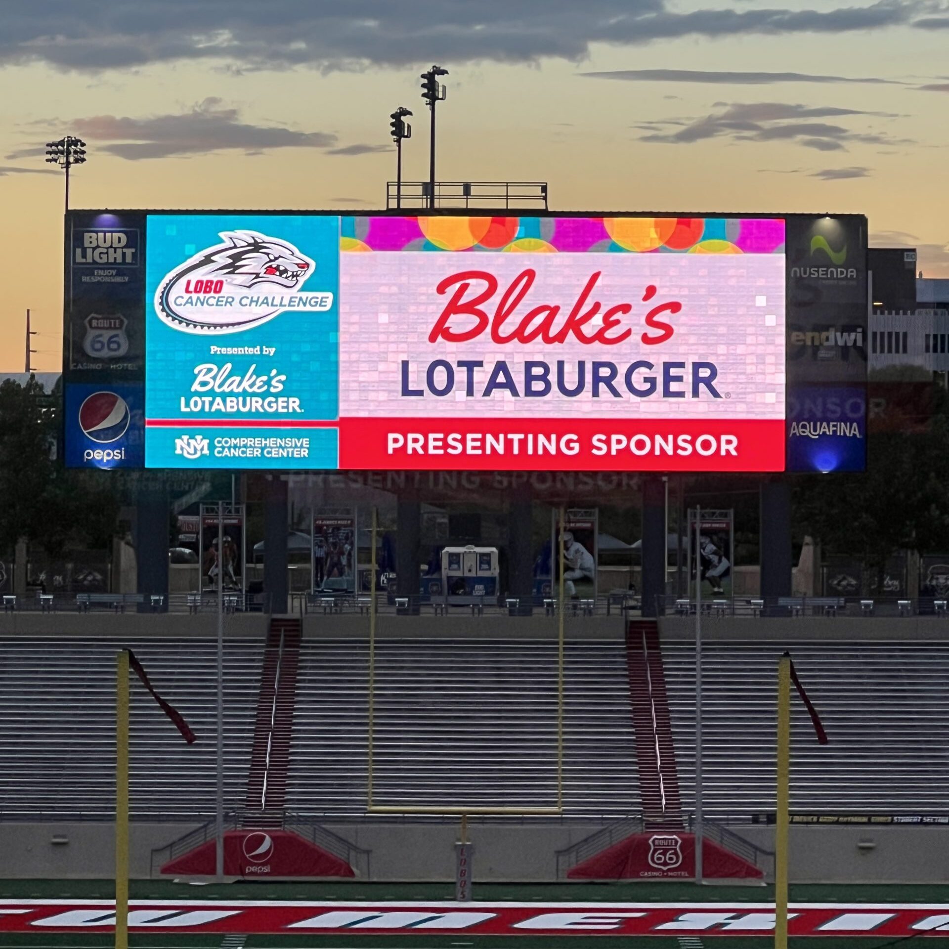 Blake's Lotaburger logo on an electronic billboard over a grand stand
