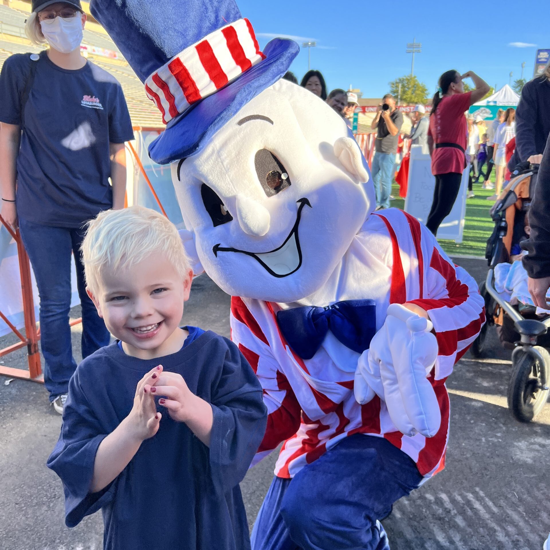 Child getting his photo taken with Blake's Mascot
