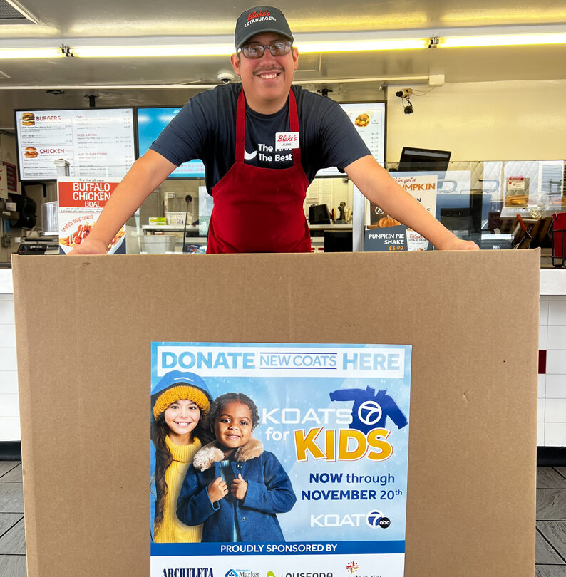 A Blake's employee holding a KOATS for Kids donation box