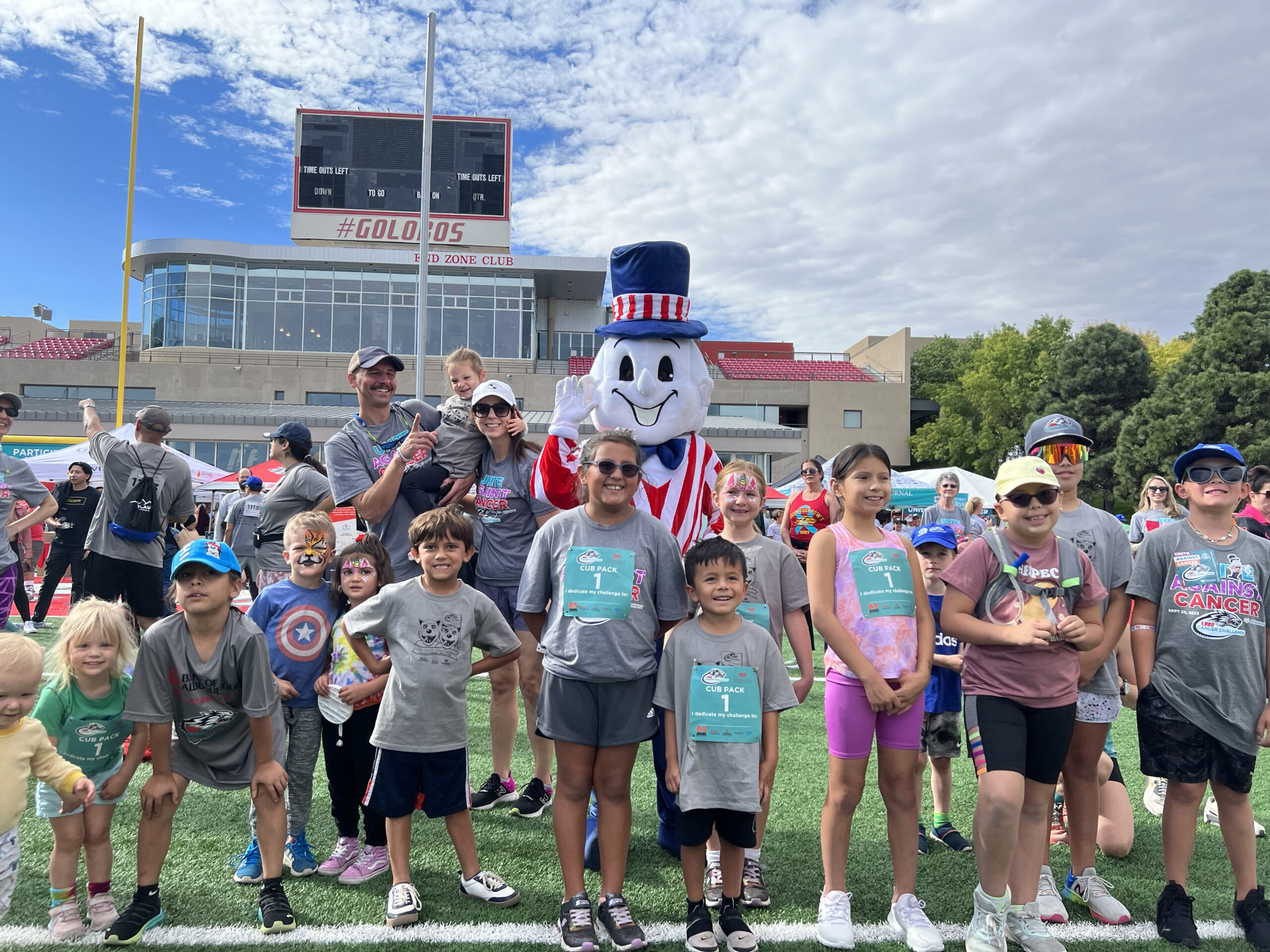 Blake's Mascot standing in a group photo with kids