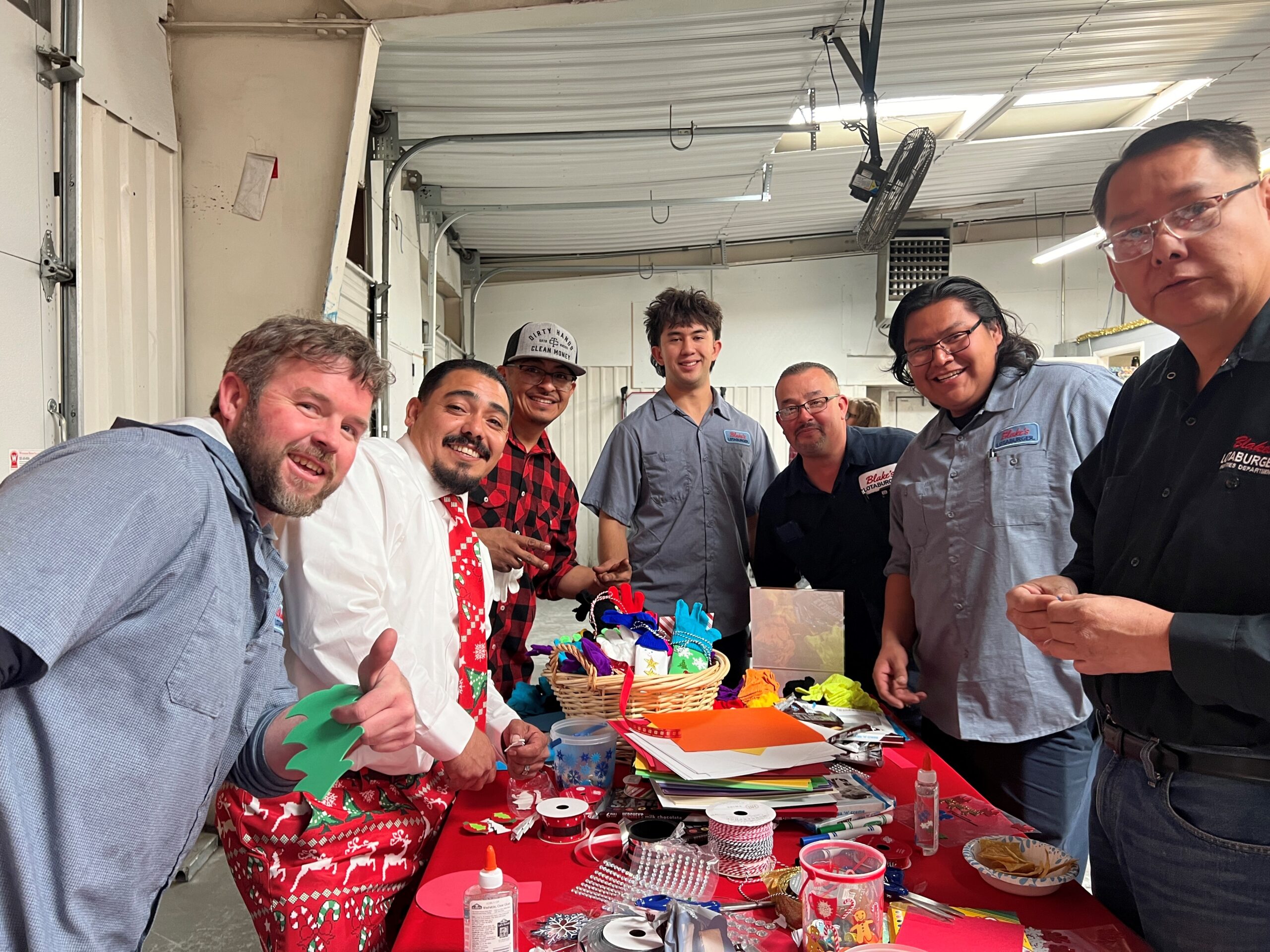 Blake's team standing over a table with Christmas craft supplies