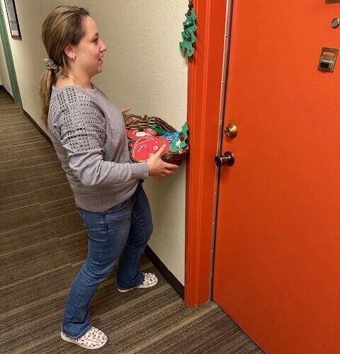 Woman holding a basket of hand made Christmas decorations
