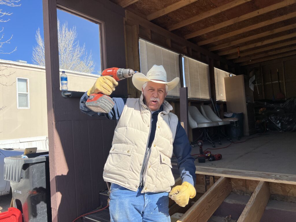 Blake's team member holding a drill