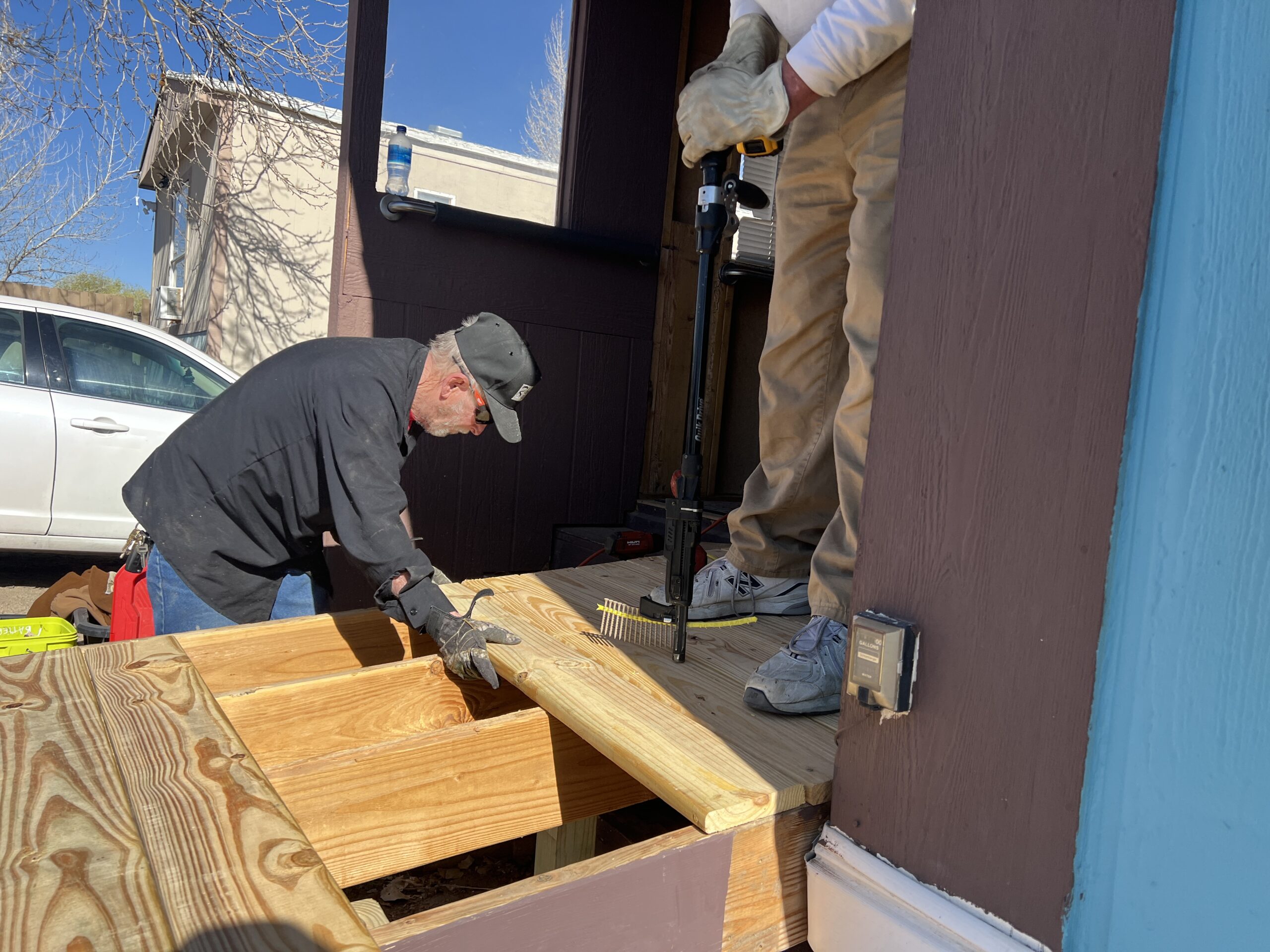 Blake's team member installing boards over wooden slats