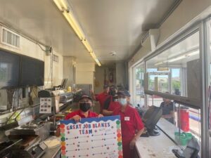 view of Grants & Gallup team with card with wide shot over kitchen