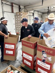 Team members from Blake's carrying and filling donation boxes.