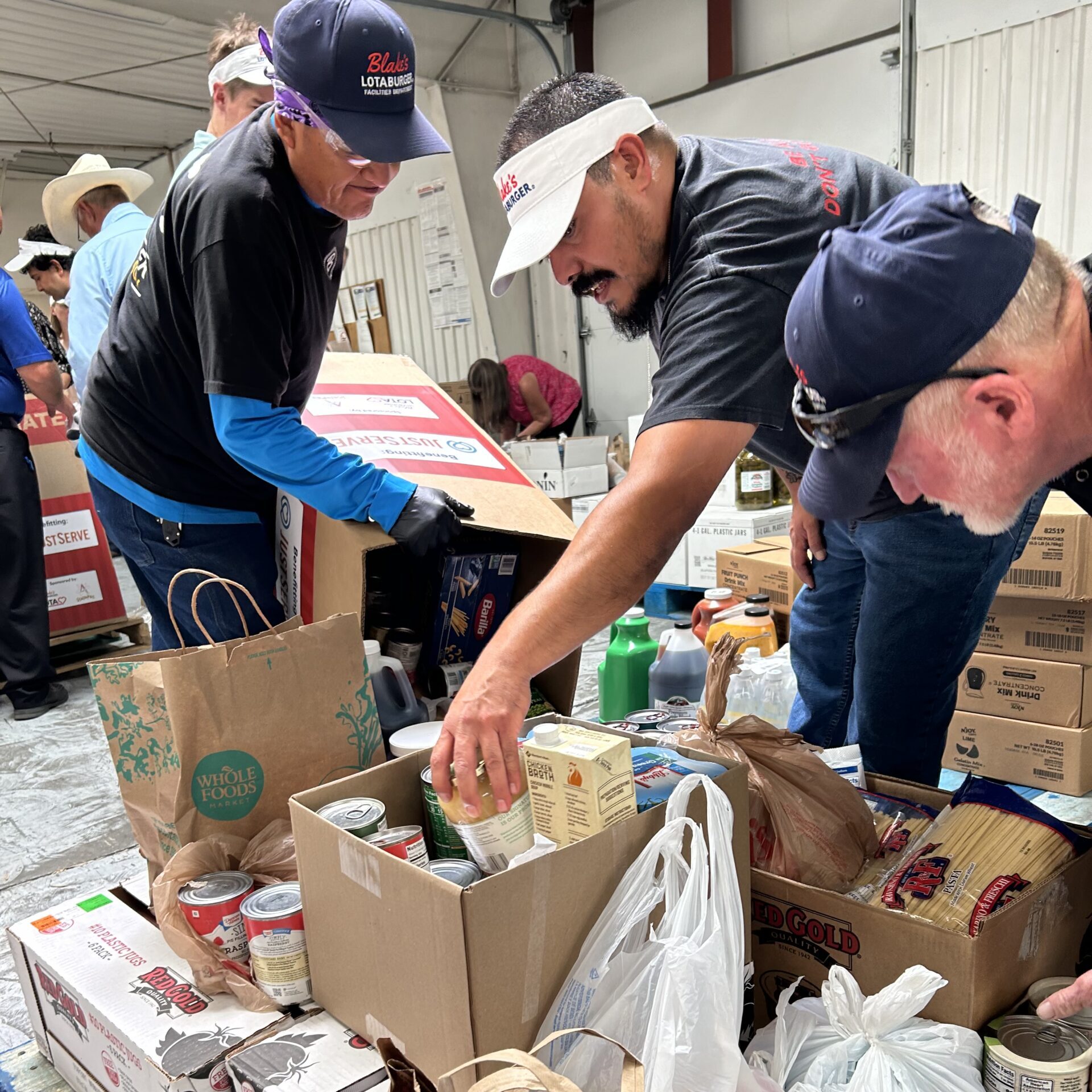 Team Blake's helping box donations with the Albuquerque Isotopes