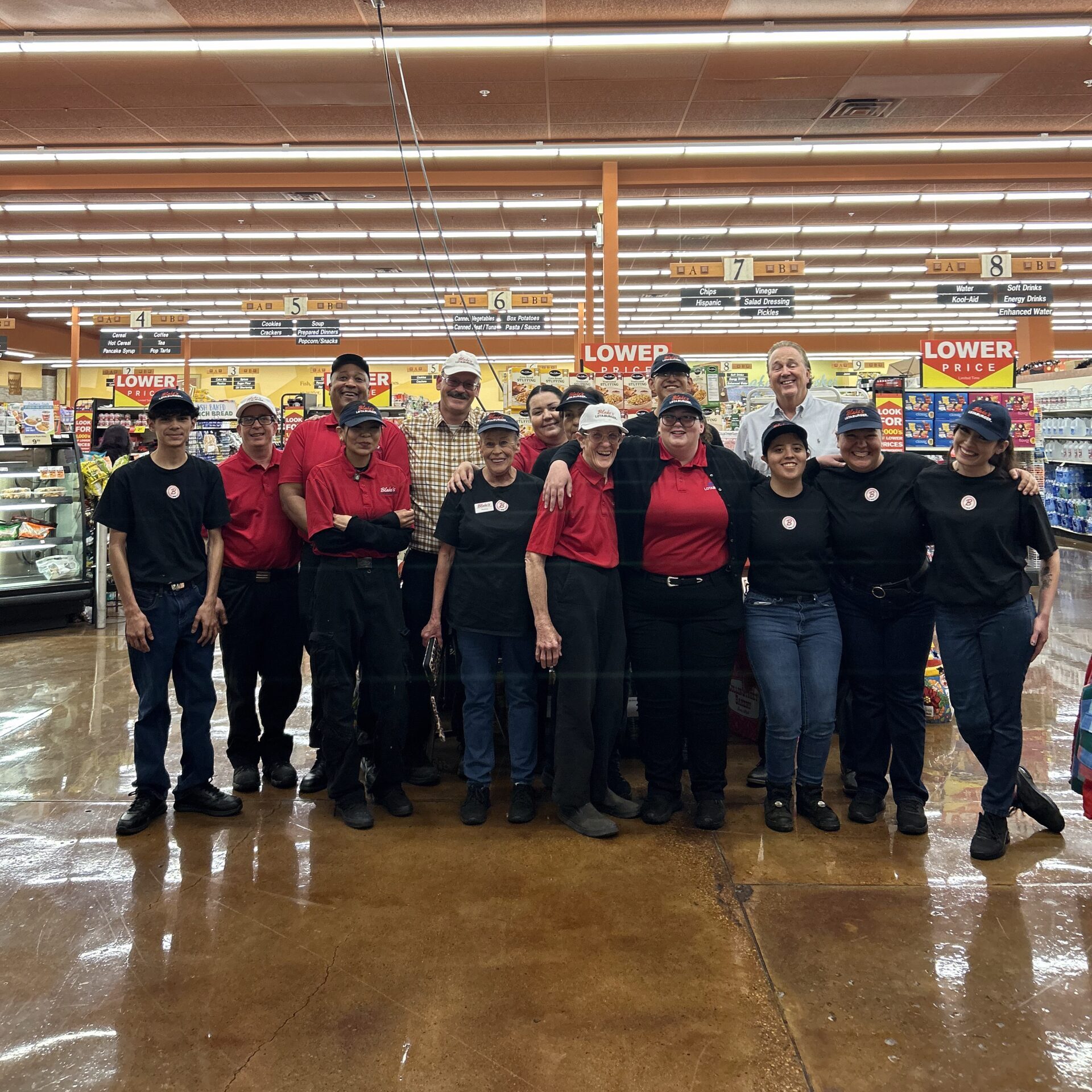 Blakes team taking a group photo in a store wearing Blakes gear