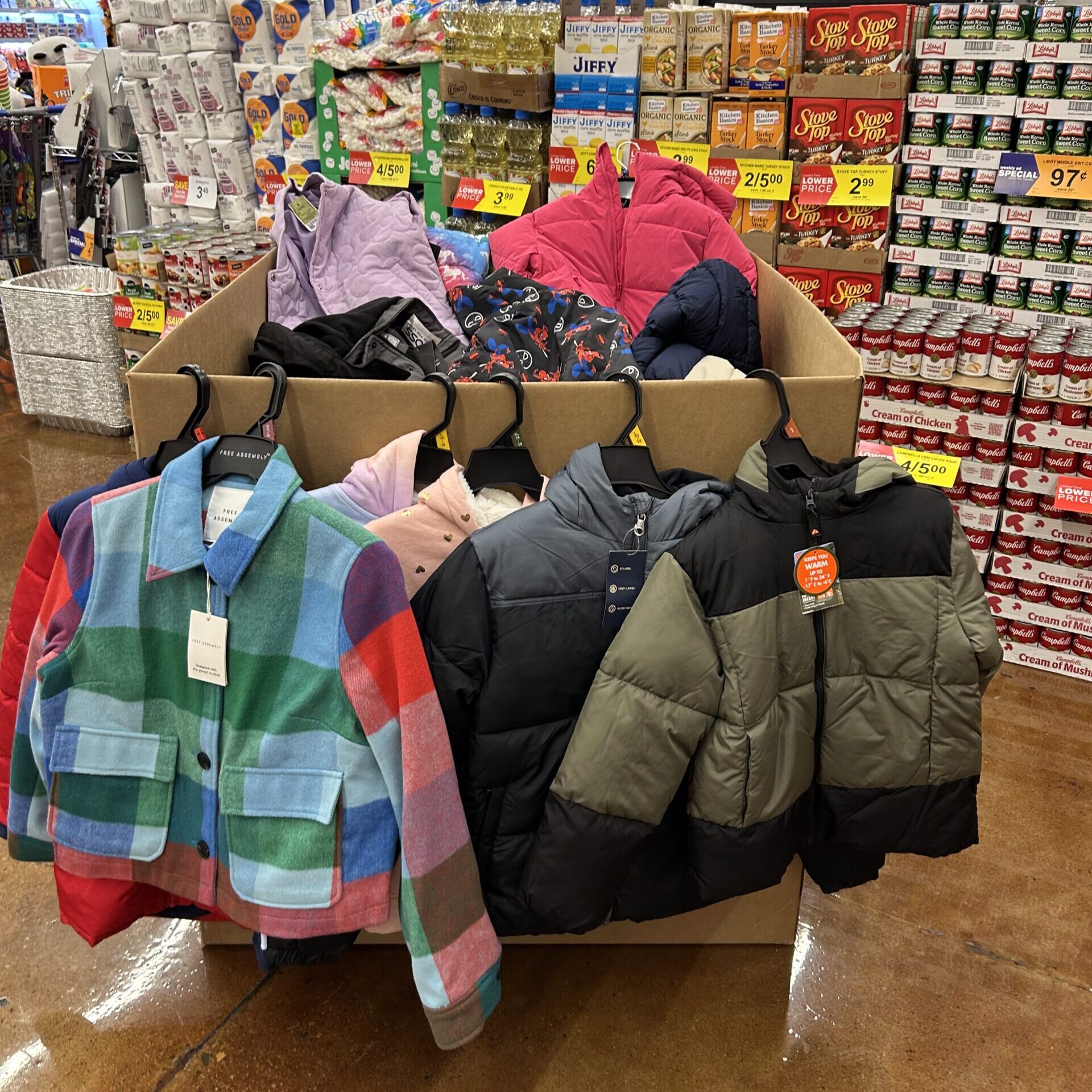 image of different colored kids coats hanging on a donation box