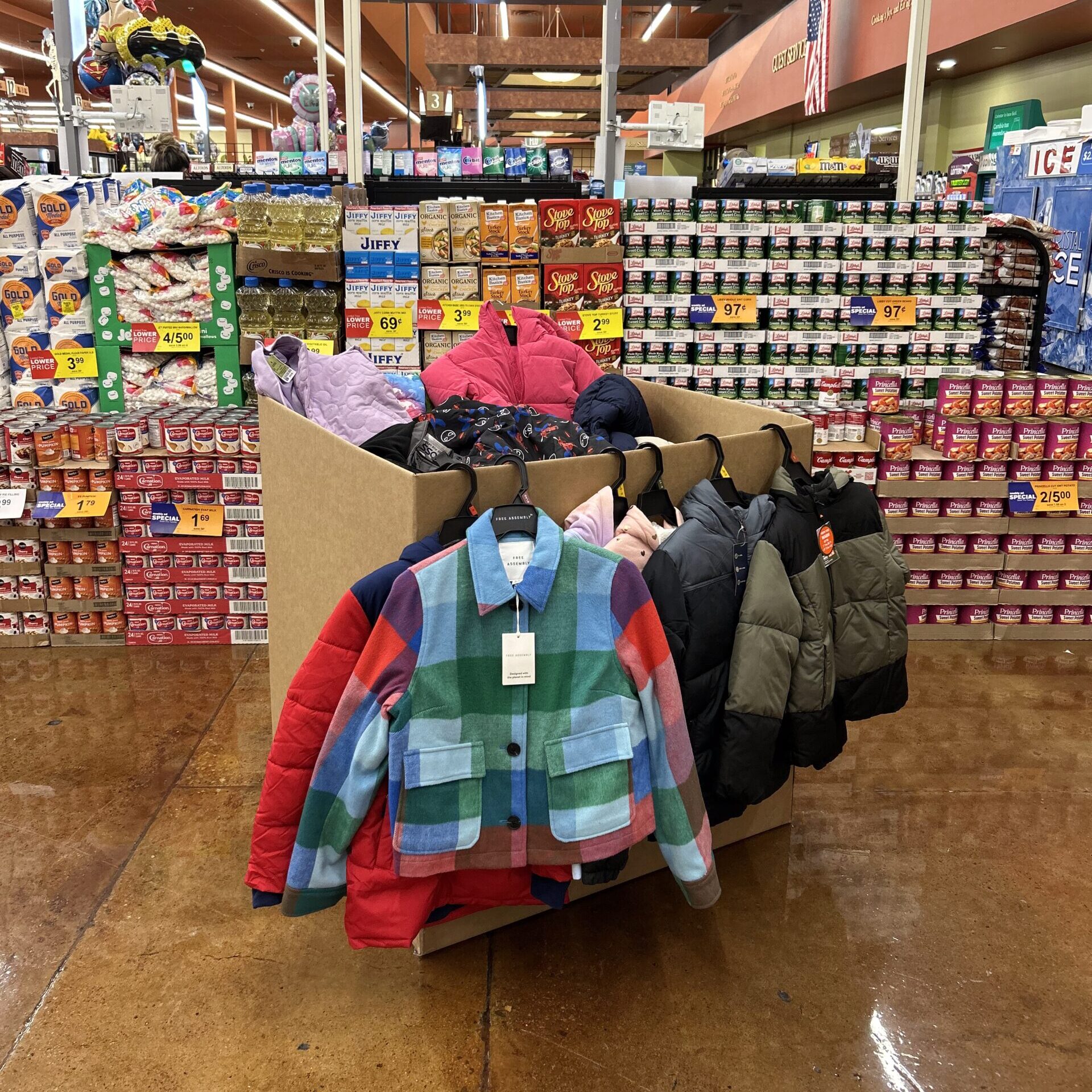image of different colored kids coats hanging on a donation box in a store