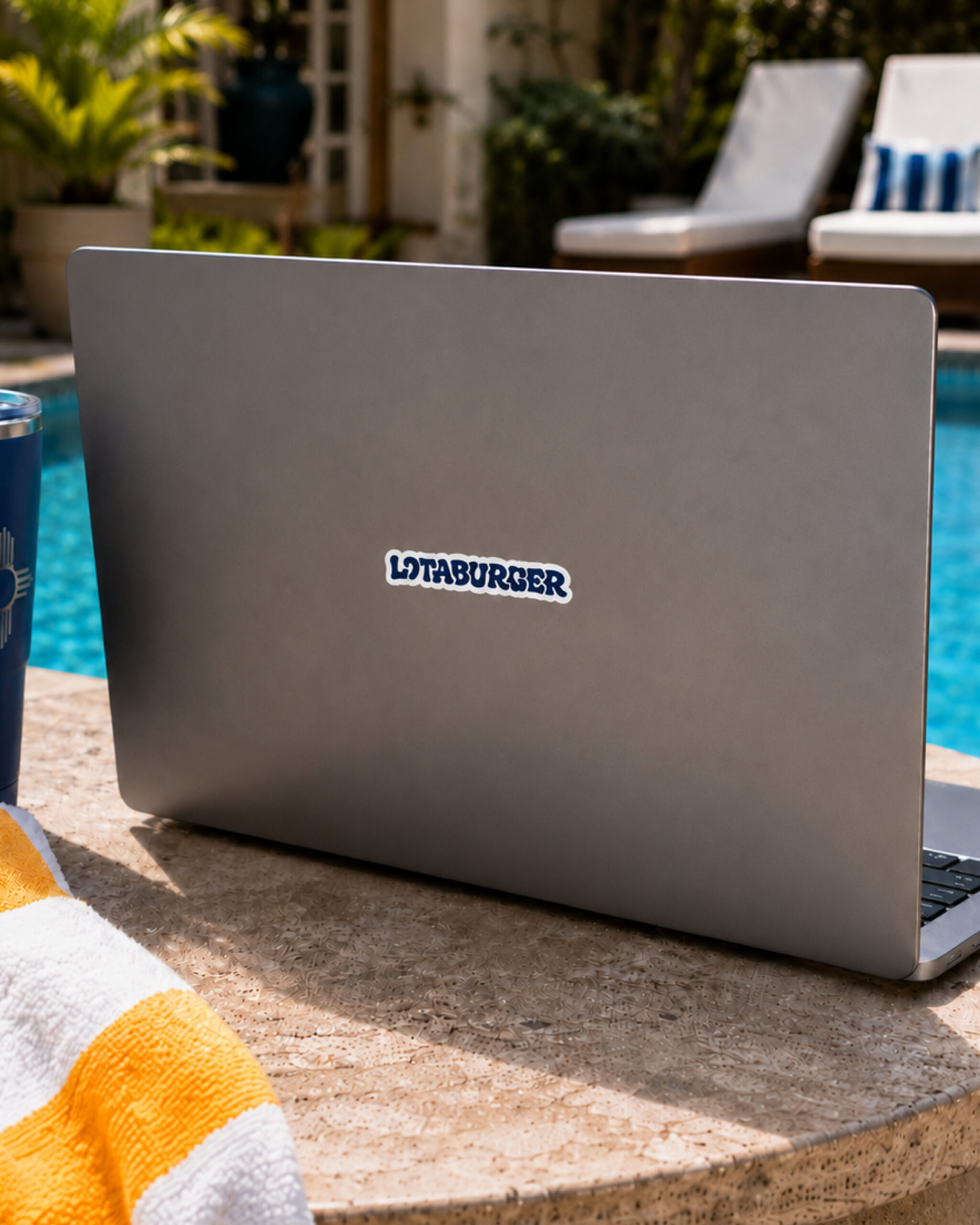 a laptop with a blue lotaburger sticker on it
