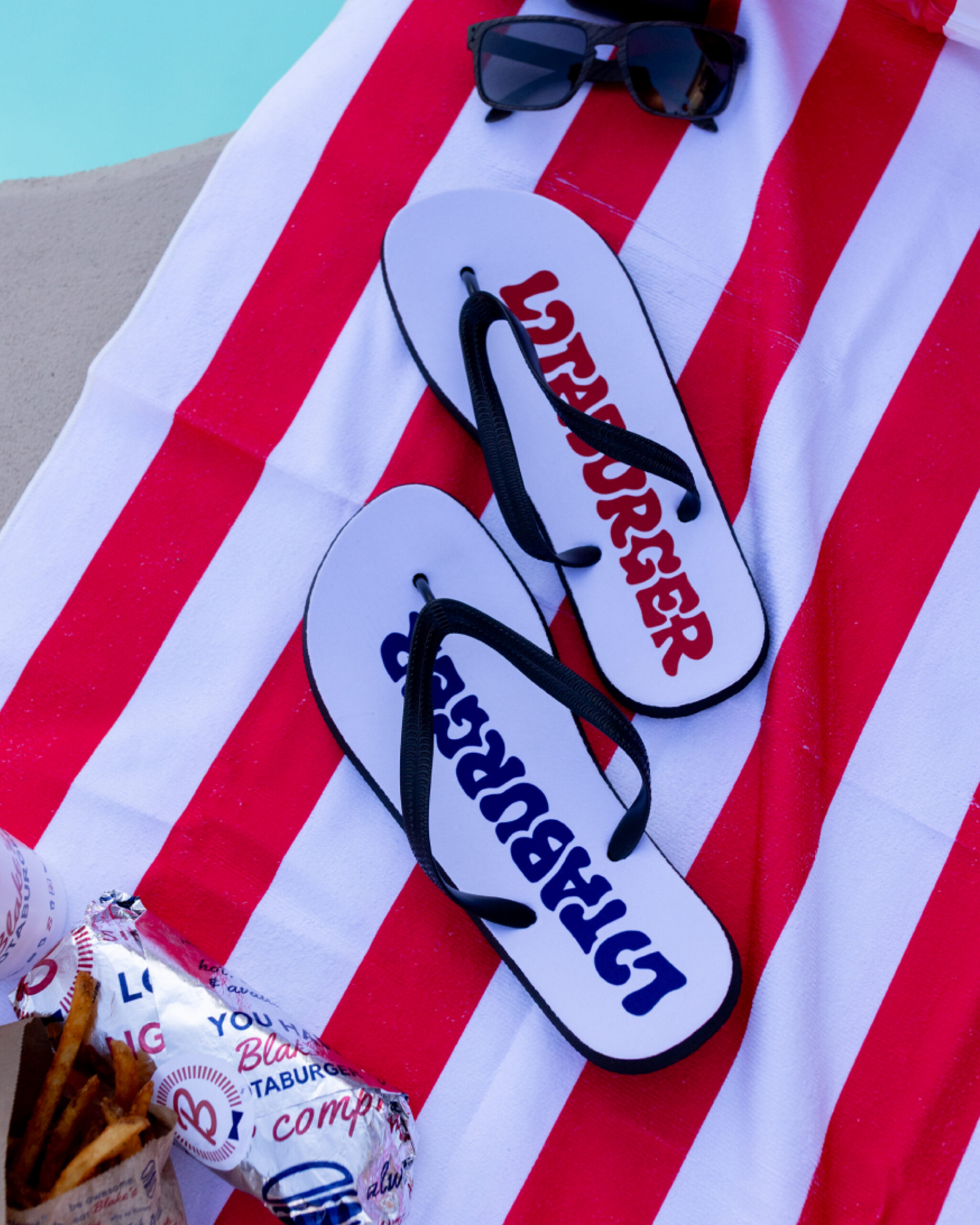 flip flops with the word lotaburger written on them in blue and red