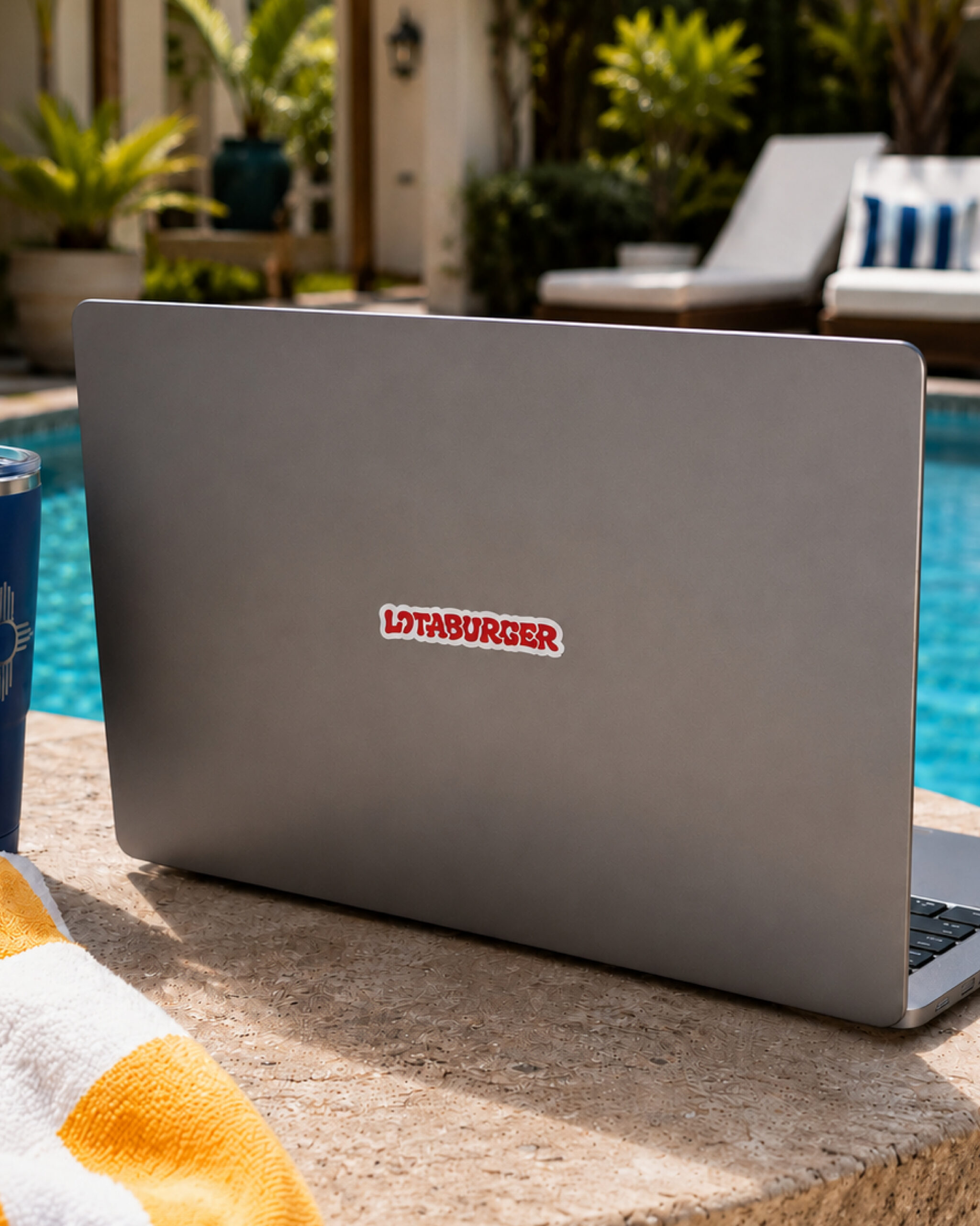 a laptop with a red LOTABURGER sticker on it